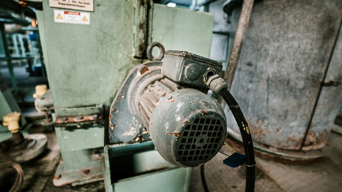 Gray industrial AC motor on a workbench