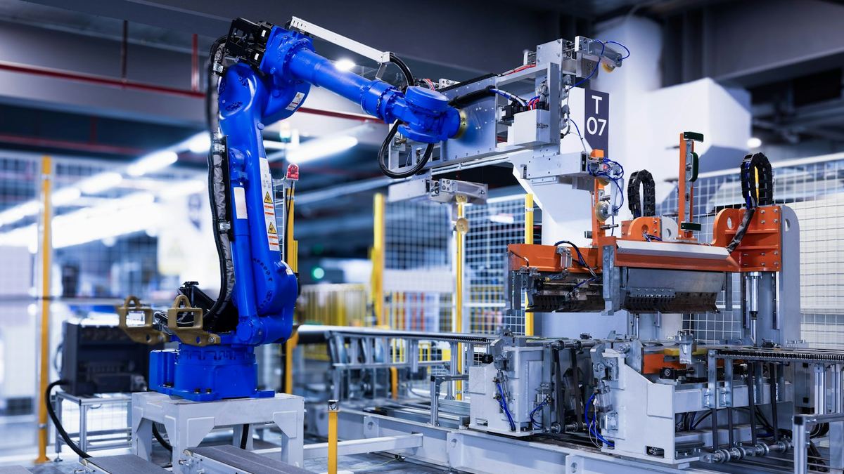 Blue industrial robotic arm on a factory assembly line