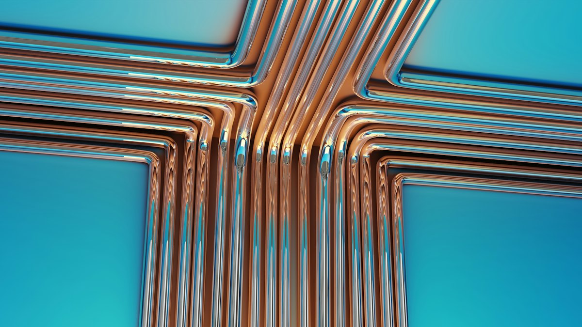 Copper pipes and press fittings arranged on a blue background