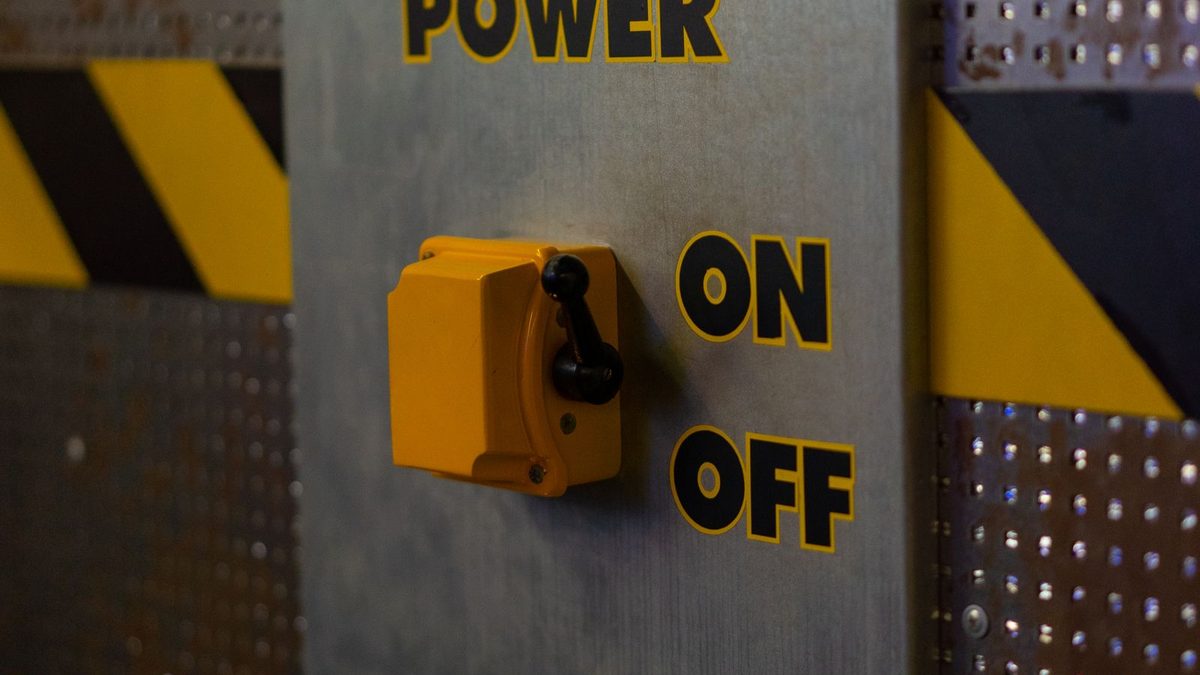 Industrial power on/off control panel with a yellow safety switch