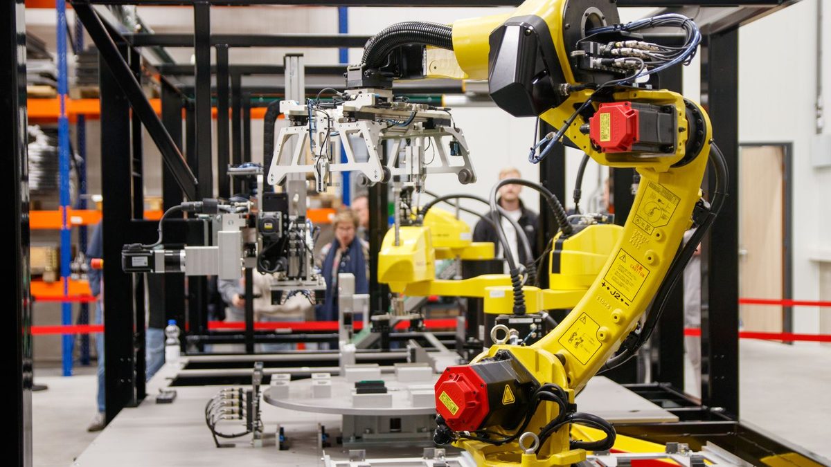 Yellow industrial robotic arm on a factory automation line