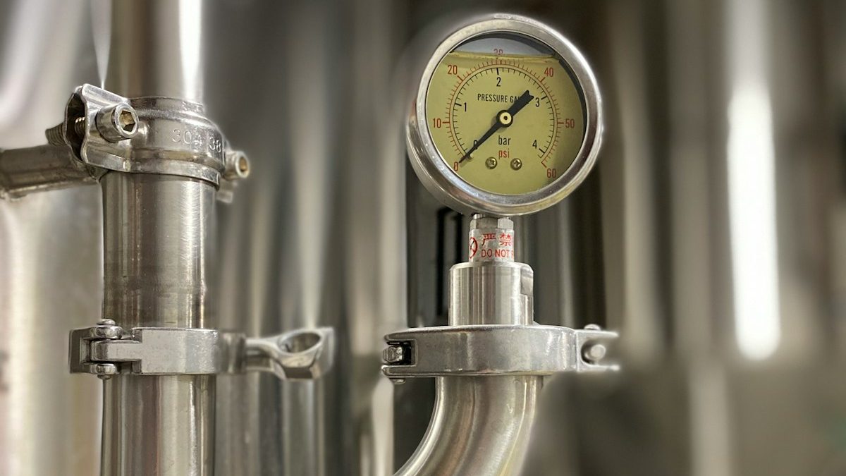 A pressure gauge on a stainless steel sanitary process line